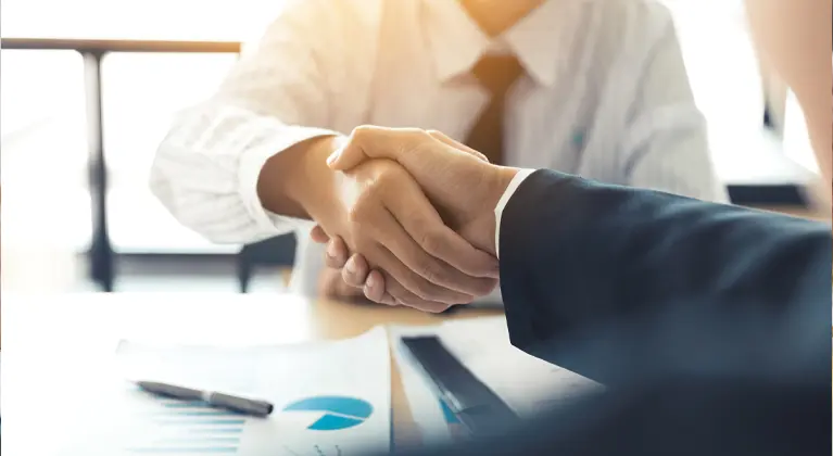 Two men shaking hands after making an agreement