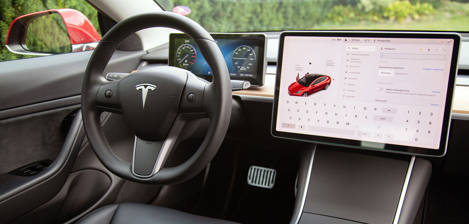 Tesla steering wheel and touchscreen display symbolizing AI-powered vehicle technology involved in NYC crash liability cases.