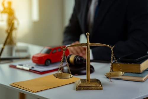 Queens car accident lawyer reviewing liability and legal options after a motor vehicle accident.
