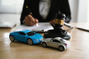 Toy cars and judge’s gavel representing car accident claims under New York's No-Fault Insurance Laws